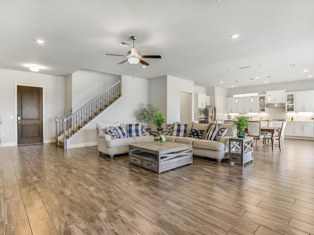 living room featuring ceiling fan and wood-type flooring