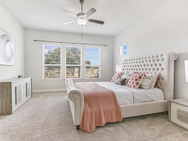 bedroom featuring baseboards, multiple windows, ceiling fan, and carpet flooring