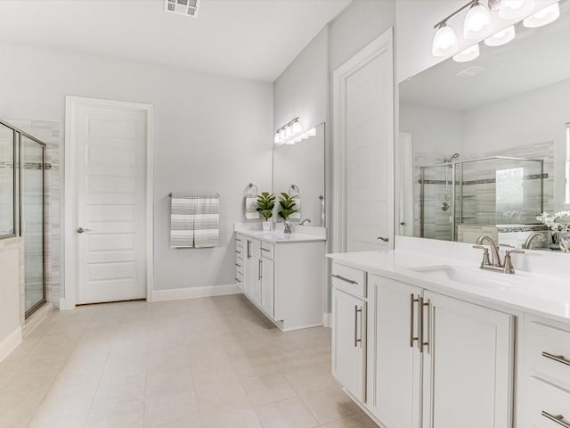 bathroom with tile patterned flooring, two vanities, a sink, baseboards, and a shower stall