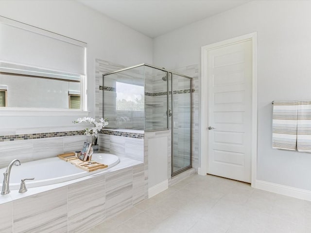 full bath with tile patterned flooring, a shower stall, a bath, and baseboards