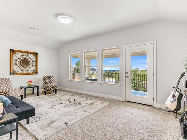 sitting room featuring carpet, visible vents, vaulted ceiling, and baseboards