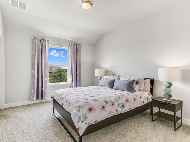 bedroom with carpet, visible vents, vaulted ceiling, and baseboards