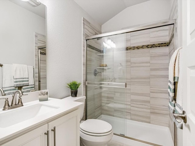 full bath with a textured wall, lofted ceiling, toilet, vanity, and a shower stall