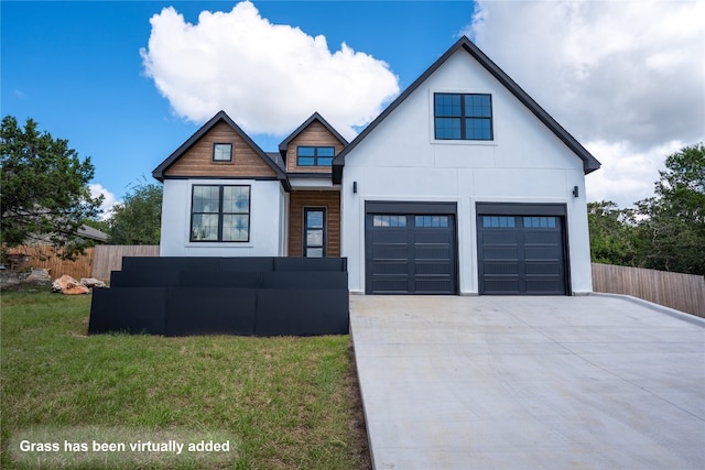 view of front of house with a garage and a front yard