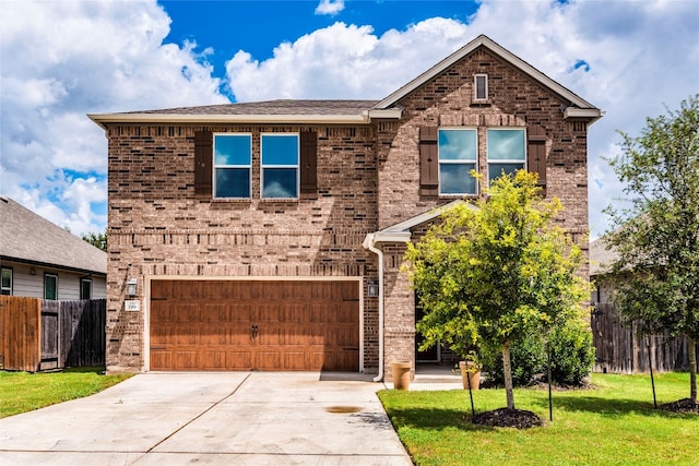 view of front property with a garage and a front yard