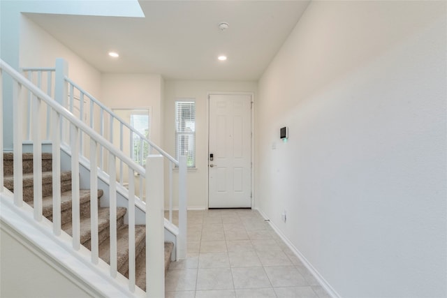 tiled entryway featuring a skylight