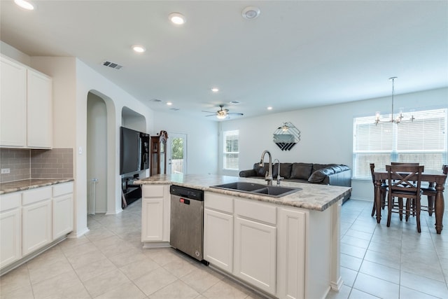 kitchen featuring pendant lighting, ceiling fan with notable chandelier, dishwasher, sink, and white cabinets