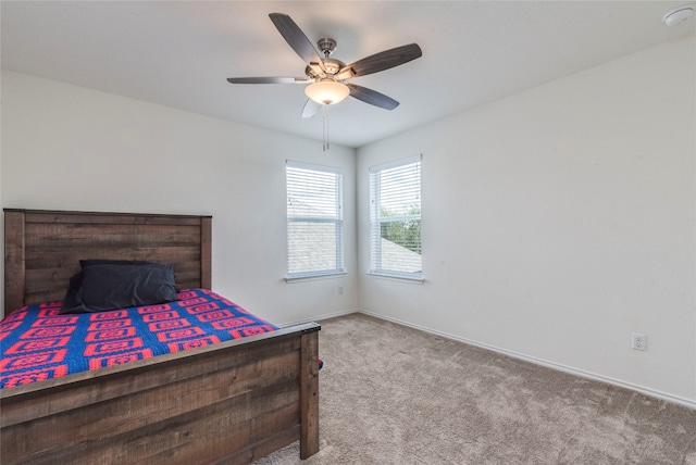 bedroom featuring light colored carpet and ceiling fan