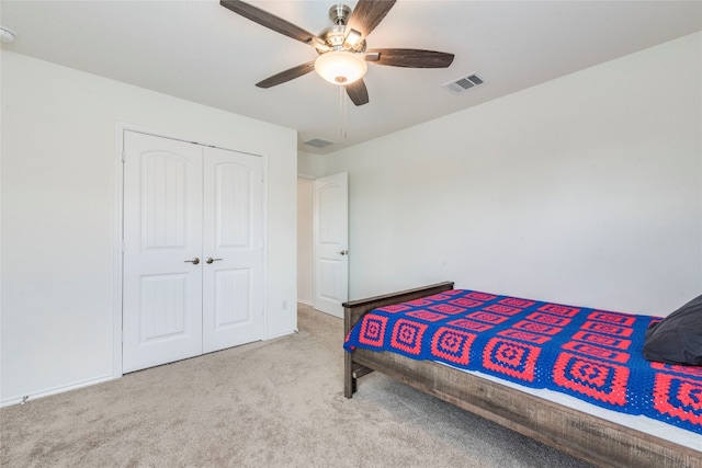 bedroom featuring a closet, ceiling fan, and light carpet