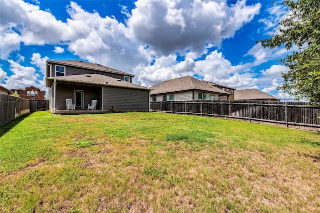 rear view of house with a yard