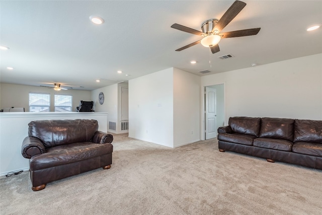 carpeted living room featuring ceiling fan