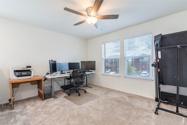 carpeted home office with ceiling fan