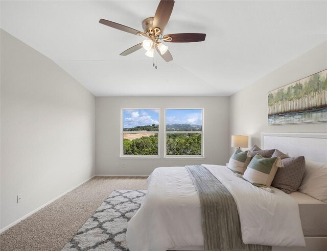 carpeted bedroom with baseboards and a ceiling fan