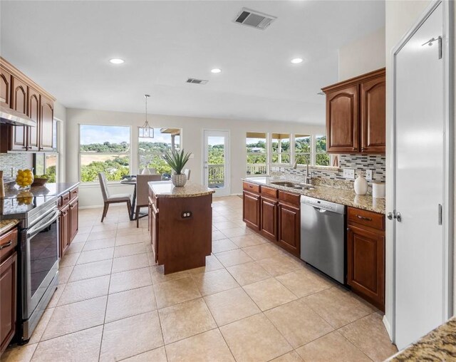 kitchen featuring tasteful backsplash, visible vents, appliances with stainless steel finishes, and a sink