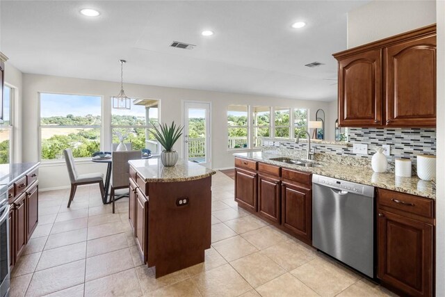 kitchen with visible vents, backsplash, dishwasher, and a sink