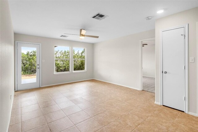 empty room with visible vents, baseboards, and a ceiling fan