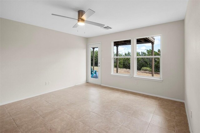 empty room featuring visible vents, baseboards, and ceiling fan