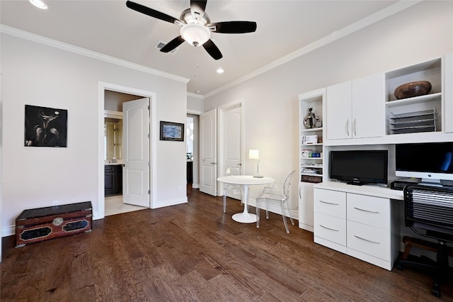 office space featuring built in desk, ceiling fan, dark hardwood / wood-style flooring, and crown molding