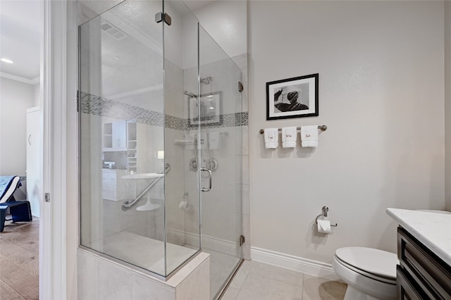 bathroom featuring tile patterned flooring, an enclosed shower, toilet, vanity, and ornamental molding