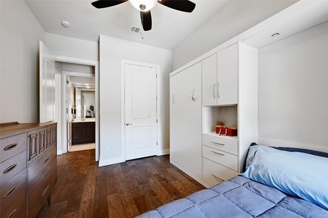 bedroom featuring ensuite bath, ceiling fan, and dark hardwood / wood-style floors