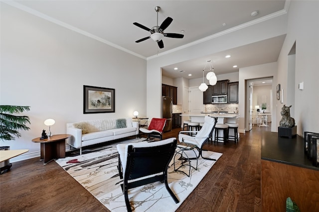 living room with ceiling fan, ornamental molding, and dark hardwood / wood-style flooring