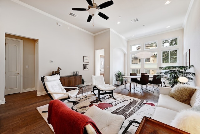 living room with ceiling fan, dark hardwood / wood-style flooring, and crown molding