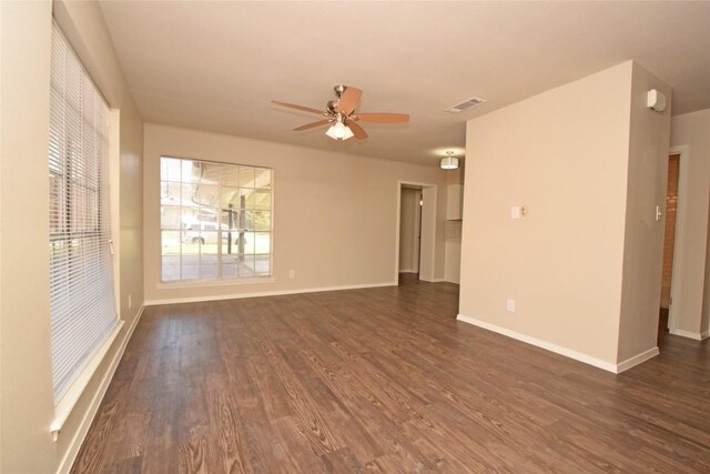 unfurnished room featuring dark wood-type flooring and ceiling fan