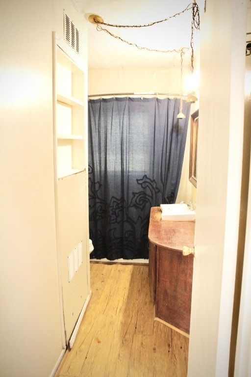 bathroom featuring vanity, toilet, and wood-type flooring