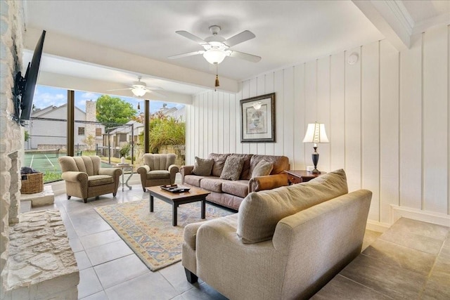 tiled living room with ceiling fan