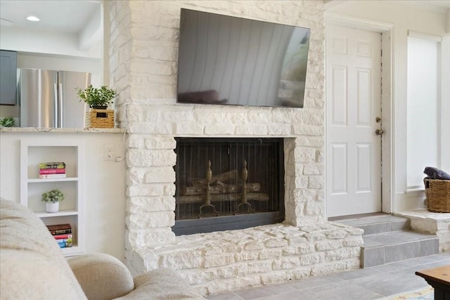 living room with a fireplace and built in features