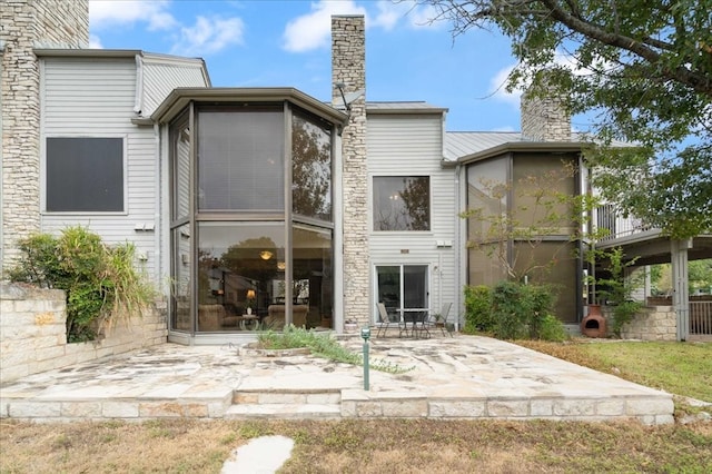 back of property with a patio