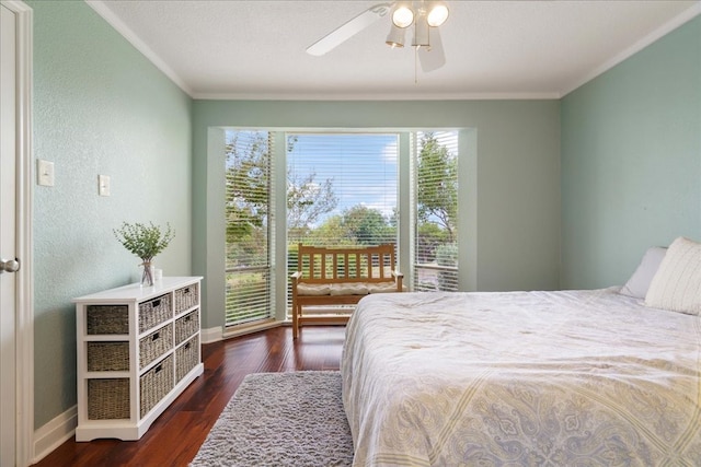 bedroom featuring dark wood-type flooring, ceiling fan, and crown molding