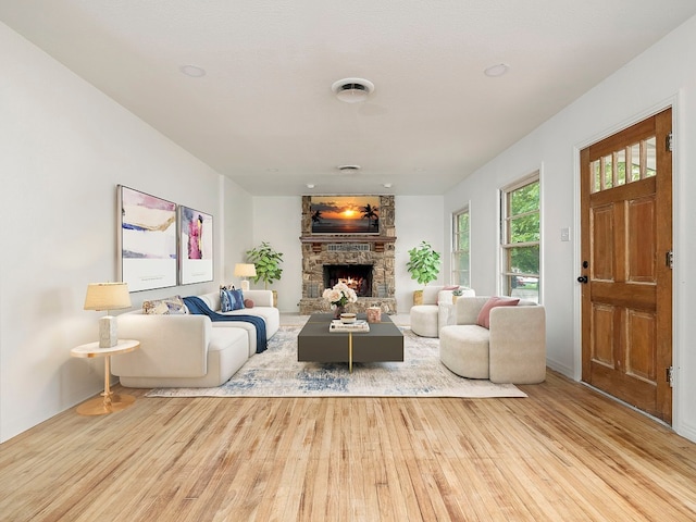 living room featuring a fireplace and light hardwood / wood-style flooring