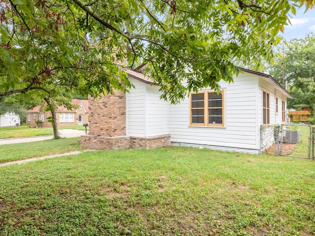 view of side of property with a lawn