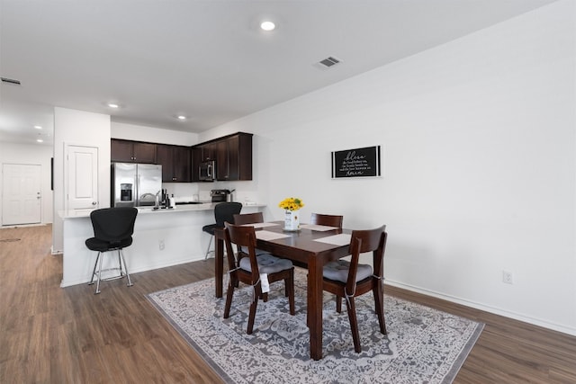 dining space with dark hardwood / wood-style floors