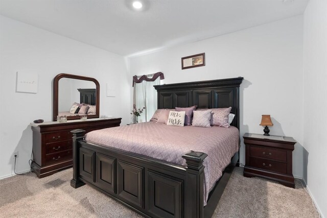 bedroom featuring light colored carpet