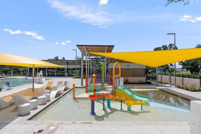 view of playground with a community pool