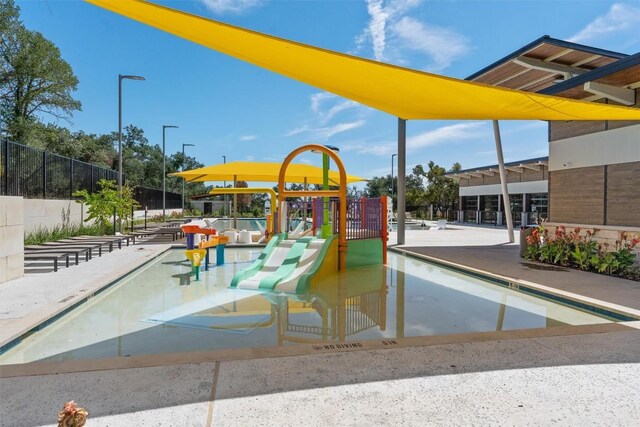 view of pool with a playground