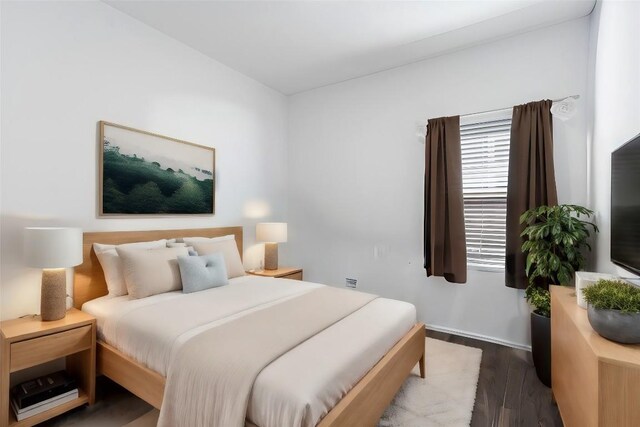 bedroom with hardwood / wood-style flooring