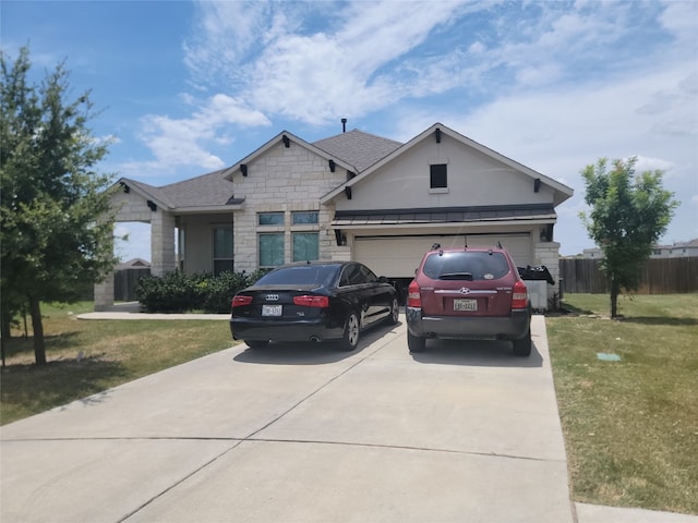 view of front of home with a front yard and a garage