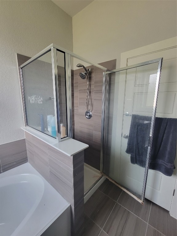 bathroom with shower with separate bathtub