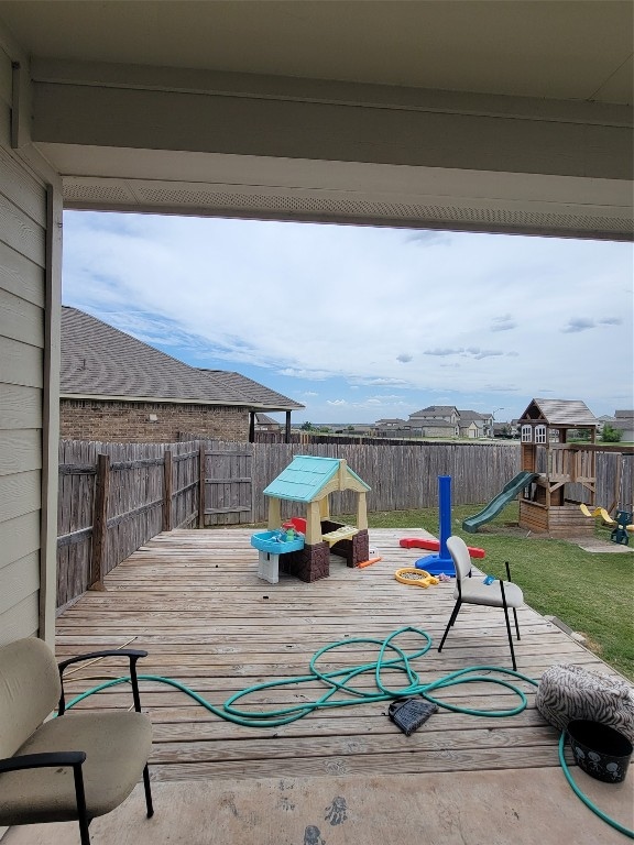 view of patio / terrace with a wooden deck and a playground