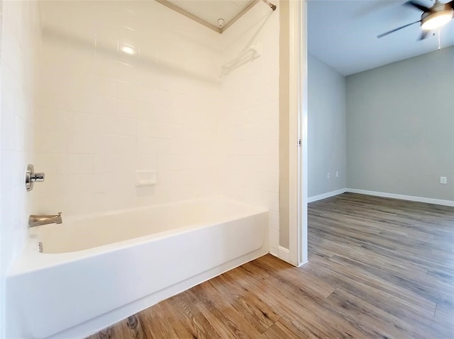 bathroom featuring wood-type flooring, tub / shower combination, and ceiling fan