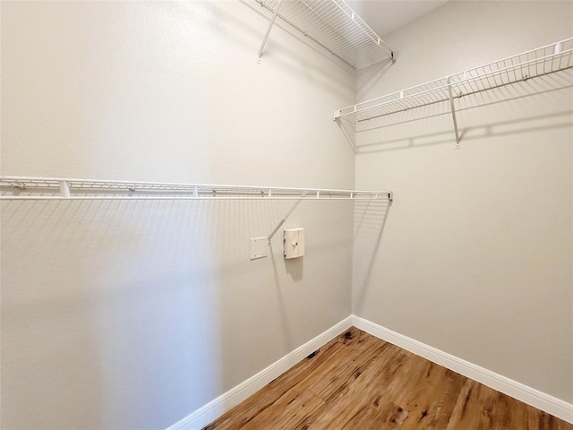 walk in closet featuring hardwood / wood-style floors