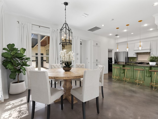 dining room featuring crown molding and an inviting chandelier