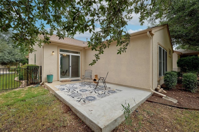 rear view of house featuring a yard