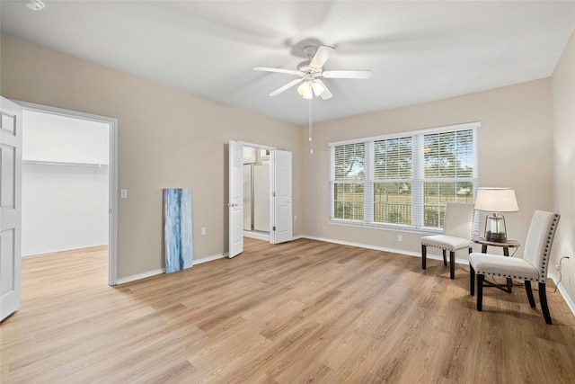 sitting room with ceiling fan and light hardwood / wood-style floors