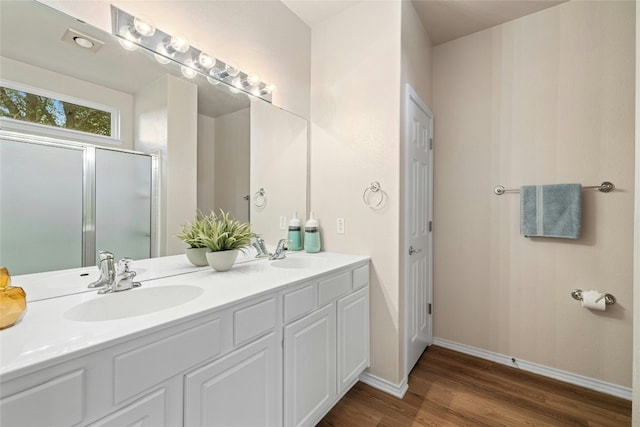 bathroom with hardwood / wood-style floors and vanity