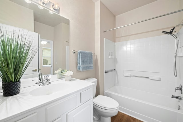 full bathroom featuring bathing tub / shower combination, vanity, wood-type flooring, and toilet