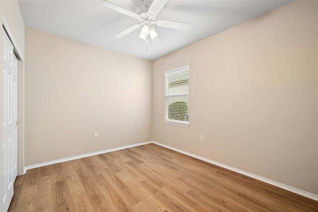 empty room with ceiling fan and light hardwood / wood-style floors